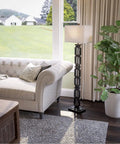 Tall Black Floor Lamp With White Rectangular Shade, 59.5 Inch Height, 16 Inch Width, 9 Inch Extension, 3 Way Socket Switch, Plastic Construction, Uses One 150 Watt Bulb, Easy Assembly With Mounting Instructions by a sofa in a living room.