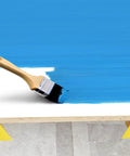 A wooden brush applying blue paint on a surface supported by Premium Solid Gold 36 Piece Painters Pyramid Stands For Cabinet Doors And Furniture Risers Mini Cone Tripod Heavy Duty Spray Paint Rack No Fuss Setup Pretty Sweet Woodworking Gear.