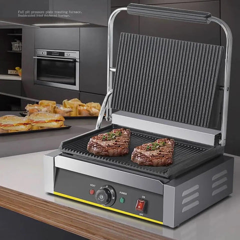 Heavy Duty 2200W Commercial Sandwich Maker And Electric Grilled Toaster grilling two steaks on a non-stick press with adjustable thermostat.