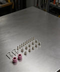Solid 24 Piece Plasma Cutter Consumables Kit That Totally Slays SG 55 AG 60 showing nozzles, electrodes, and shields on a metal surface.