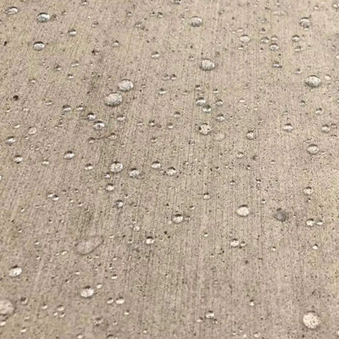 Water droplets on concrete surface showing effect of Odorless Concrete And Masonry Waterproofer Spray On For 1 Gallon Ready To Use