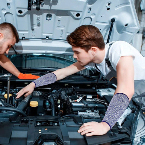 Mechanic wearing Five Pack Cut Resistant Arm Sleeves For Men And Women, Level Five Bite Proof Forearm Guards, repairing a car.