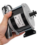 Daily Driver 24 Volt 500 Watt Gear Reduction Brushed DC Motor held in hand showing black iron casing and electrical connections.