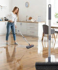 Woman using 64 Inch Floor Scrub Brush With 360 Degree Swivel Head And Detachable Long Handle For Heavy Duty Cleaning in kitchen