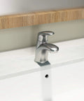 Colony Pro Single Handle Bathroom Faucet With Metal Pop Up Drain 1.2 GPM Brushed Nickel installed on white countertop