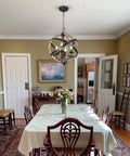 Cozy Rustic Farmhouse 4 Light Chandelier With Height Adjustable Design in a dining room, wood frame, vintage white finish.