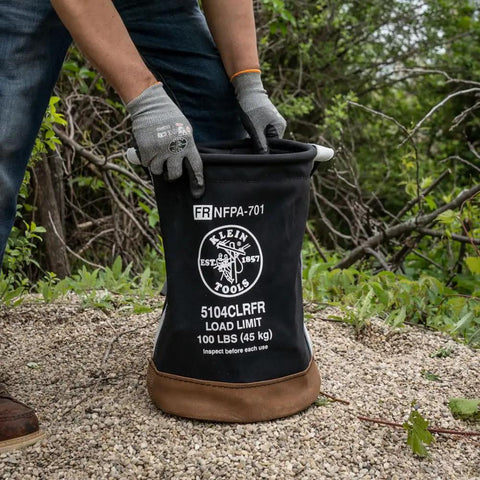 Person using Beefy Heavy Duty Canvas Tool Bucket With Zip Top Flame Resistant Closure For Overhead Lifts outdoors