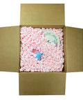 Solid Antistatic Packing Peanuts In Bulk Six Cubic Feet Of Super Snug White Cushioning in a cardboard box with fragile items.