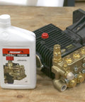 Premium Pump Oil For Pressure Washers 1 Liter Non Detergent Non Foaming Formula Delivers Strong Rust And Oxidation Protection With Easy Fill Neck Great Choice For Gas Powered Washers next to pressure washer pump on wooden table