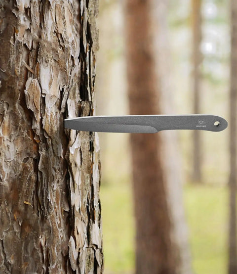 10.2 Inch Throwing Spear from Six Pack set embedded in tree trunk, showcasing 0.236 Inch Thick Full Tang design