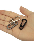 Hand holding three Mini Carabiner Clip 10 Pack Aluminum Alloy Tiny Spring Snap Hooks For Paracord EDC Keychains And Backpack Gear Black