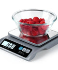 Must Have Digital Kitchen Scale With 13lb Capacity And 0.1g Precision Removable Stainless Steel Pan Backlit LCD Display Perfect For Cooking And Baking Easy To Use For Precise Weighing In Grams And Ounces Grey with glass bowl of raspberries
