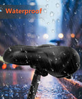 Super Comfy Wide Bike Seat For Women And Men With Memory Foam Cushion Anti Shock Padding under rain showcasing waterproof feature