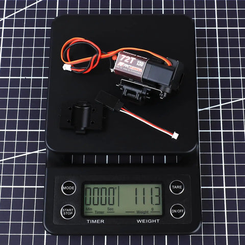 Full Metal 2 Speed Transmission Gearbox With Base For 1 To 18 FMS Crawler Parts Black on digital scale showing 111.3g