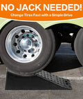 Dual Axle Tandem Wheel Ramp With 5.5 Inch Lift For Trailer And RV Tire Changes holding an RV tire with heavy-duty concave design.