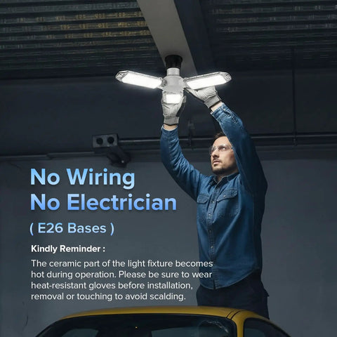 Man installing Three-Panel Deformable LED Garage Light With 3300 Lumens Of 5000K Daylight, 30W Power in a garage ceiling