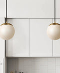 Chic Satin Brass Hanging Globe Pendant Light For Modern Rooms One Light Fixture With Clean Minimal Design in kitchen