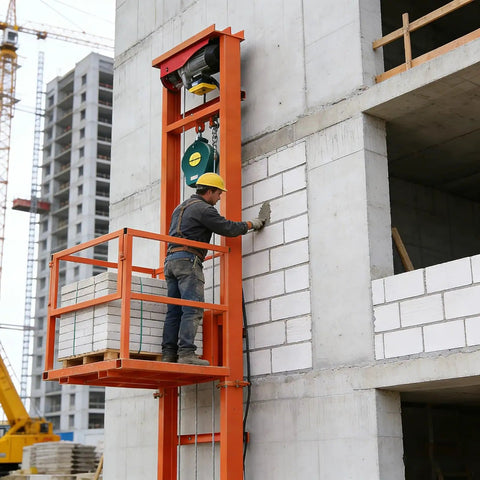 Heavy Duty Electric Freight Workhorse Featuring Quiet Hydraulic Wall Mounted Vertical Hoist, 16 Foot Travel Height, 2200 Lb Capacity in use at a construction site.