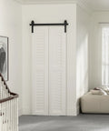 30 Inch Bi Folding Sliding Barn Door Hardware Track Kit with smooth quiet operation side mounted black rollers installed in living room