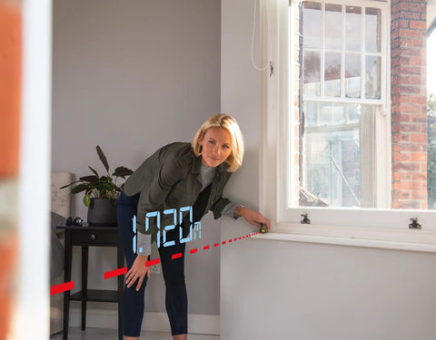 Pro 20 Meter Laser Distance Meter With Clear Digital Screen And Continuous Measurement Mode in use measuring 17.20m indoors.