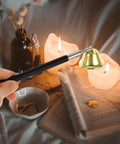 Telescopic Candle Fire Extinguisher With Extensible Copper Wick Snuffer For Home Safety used to extinguish candles.