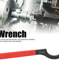 Heavy Duty ER32 Collet Wrench Made From High Speed Steel For Lathe Machines with red grip, 23cm long, in workshop setting.