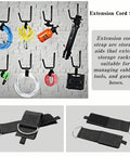 Extension cord straps displayed on a wall, managing cables and tools; product with D-ring and hook in black fabric material.