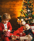 Child opening gift near Christmas tree lit with plug in fairy lights 33ft 100 LED twinkle string lights with remote timer 8 modes.