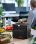 Premium 9 Liter Soft Sided Cooler Bag With Leak Proof Design Keeps Your Grub Fresh All Day on office table with sandwiches.