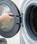 Hand using a screwdriver on a washing machine door hinge during assembly or repair.
