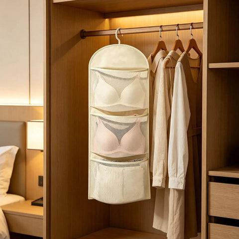 Game Changer Closet Suspending Organizer With Sturdy Metal Hanger And Three Tier Mesh Pockets For Dorm Rooms And Small Spaces hanging in a closet with bras.