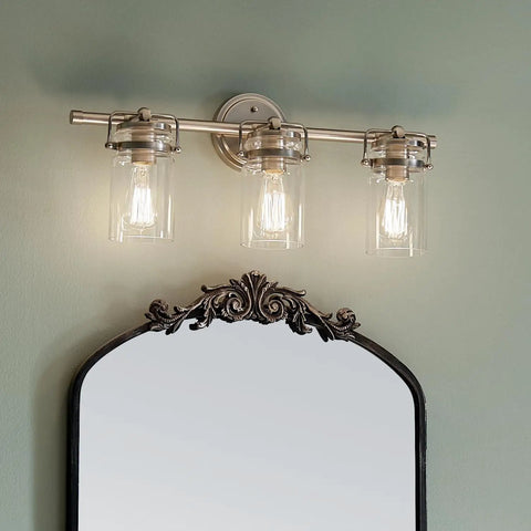 Brinley 24-Inch Three-Light Vanity Light In Brushed Nickel With Clear Glass Farmhouse Chic Bathroom Fixture Sits Above Mirror