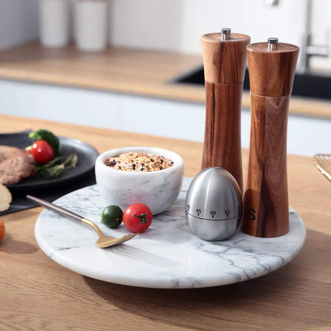 12 Inch Solid Marble Lazy Susan Turntable With Buttery Smooth Swivel Base For Zero Fuss Kitchen Countertop Organization featuring spices and utensils.