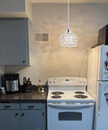 Three Light Black Hanging Ceiling Light Chandelier With Crystal Accents in a modern kitchen setting
