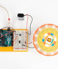 Six Pack Arduino Starter Kits For Classroom Use With English Projects Book, showing Arduino board with spinning motor project