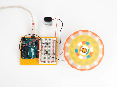 Six Pack Arduino Starter Kits For Classroom Use With English Projects Book, showing Arduino board with spinning motor project