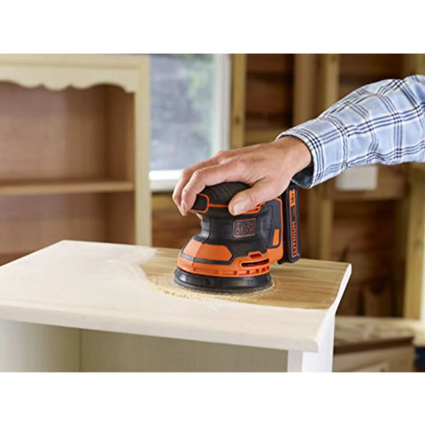 Badass 18V Cordless Orbital Sander With Killer Dust Control And Super Smooth Softgrip Handle For Hassle Free Wood Projects 12,000 Opms Compact Orange Design used on a wooden surface.