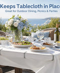 Outdoor dining setup with white tablecloth, secured by Sturdy Stainless Steel Tablecloth Clips, Rust Proof And Heavy Duty 6 Pack For Indoor Outdoor Use.