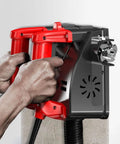 Hands gripping red handles of Badass 1680 Watt Electric Wall Planer designed for shaving off drywall and plaster.