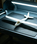 Ten Pack Carbon Fiber Wing Spar Poles for RC Planes displayed with a model glider on a textured black surface