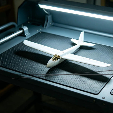 Ten Pack Carbon Fiber Wing Spar Poles for RC Planes displayed with a model glider on a textured black surface