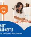 Woman changing a baby on a diaper pad, showcasing No Fuss And No Sweat 300 Pack Disposable Underpads And Chux Pee Pads Measuring 17X24 Inches With Heavy Duty Waterproof Backing For Baby Diaper Changes Pet Crate Liners And Medical Setup.
