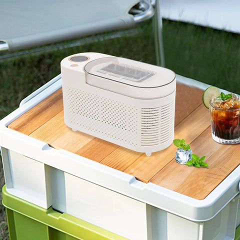 Quick Chill Portable Ice Cube Maker For Home Or Car, Slick White Compact Build, producing ice cubes on wooden table.