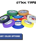 Various colors of masking tape rolls with "Stikk Tape" logo displayed, arranged in a stack. Many color options available.