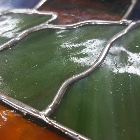 Close-up of glass art with Artist Pure 60/40 Stained Glass Solder Wire 0.125 Inch Thick 1lb Spool For Copper Foil And Came Lead Work