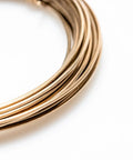 Yellow Brass Solder Wire 5 Feet Long 20 Gauge Color Match For Brass Jewelry And Electronics Lead Free Cadmium Free Contains About 38 Percent Silver Made In USA For Soldering And Welding Pro Grade coiled on white background