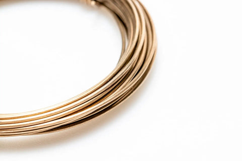 Yellow Brass Solder Wire 5 Feet Long 20 Gauge Color Match For Brass Jewelry And Electronics Lead Free Cadmium Free Contains About 38 Percent Silver Made In USA For Soldering And Welding Pro Grade coiled on white background
