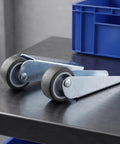 5pcs Wooden Gate Wheel Side Mount Caster with 1.5 Inch Rubber Rollers on a metal surface, showcasing sturdy design and smooth rollers.