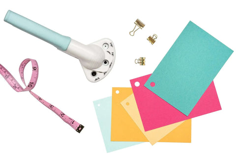 Multi Size Hole Punch For Leather, Paper, Fabric And More Rotates Through Five Hole Sizes shown beside colorful paper cards