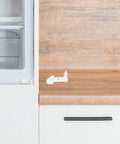 Heavy Duty Plastic Freezer Door Stop For Fridge Repair on wooden countertop, easy DIY installation for door hinge damage prevention.
